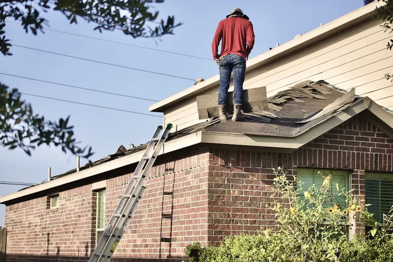 Professional roofer working on a residential roof in Shanersville